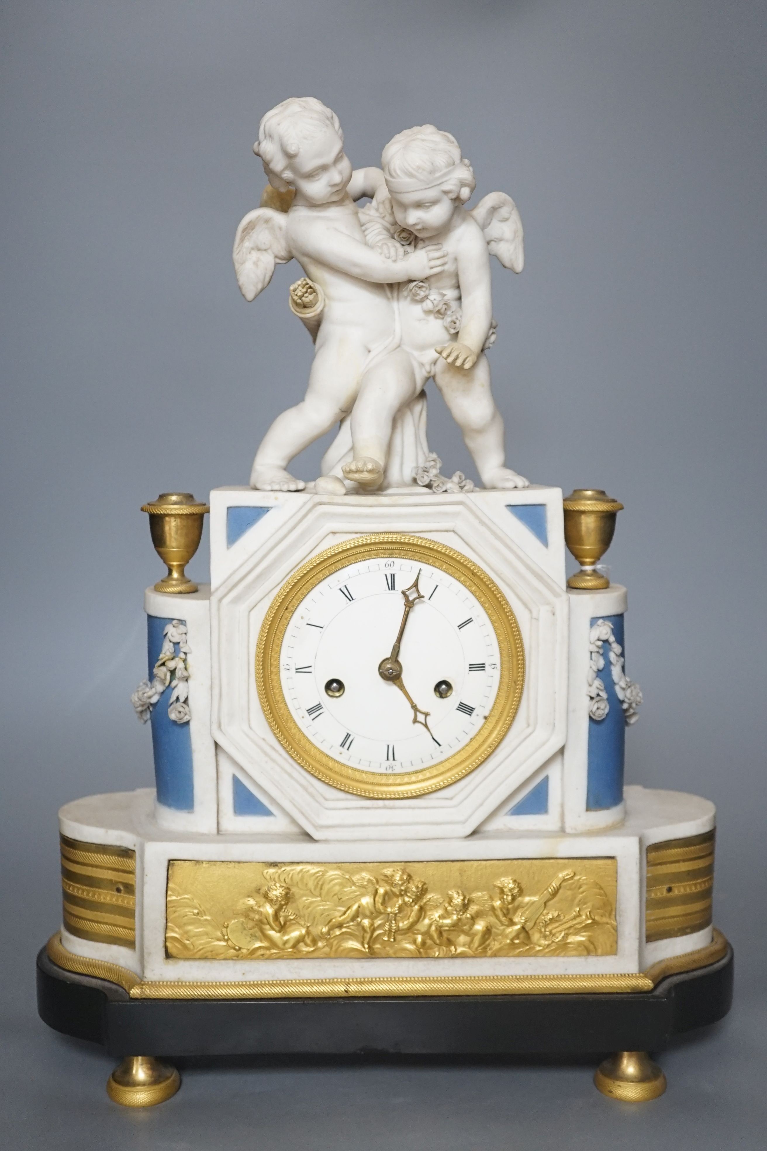 A 19th century French biscuit porcelain and ormolu mounted mantel clock, 43 cm high